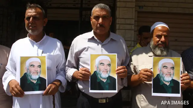 Supporters of Sheikh Raed Salah (portrait), head of the radical wing of the Islamic Movement in Israel, demonstrate in Gaza City on June 30, 2011 after the controversial Arab-Israeli Islamist leader was arrested in Londo...