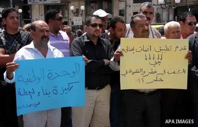 Palestinian demonstrators take part in a protest calling for Palestinian political unity between Gaza's Hamas rulers and the Fatah-dominated Palestinian Authority which rules from Ramallah, Thursday, June 30, 2011. Photo...