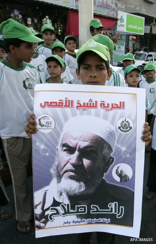 Palestinian children Supporters of Sheikh Raed Salah (portrait), head of the radical wing of the Islamic Movement in Israel, demonstrate in Rafah in the southern Gaza Strip on June 30, 2011 after the controversial Arab-I...