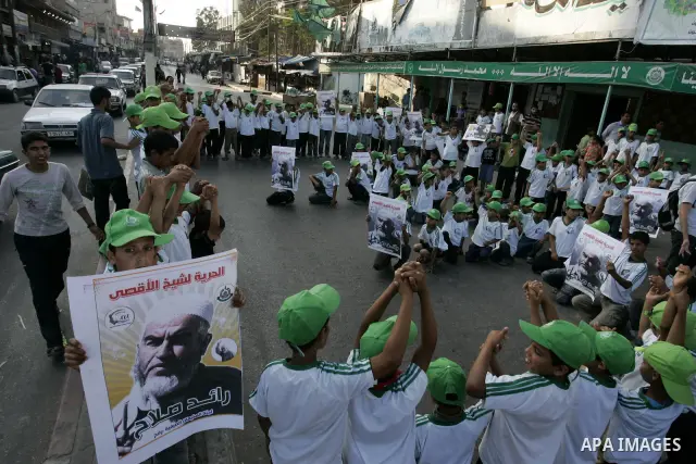Palestinian children Supporters of Sheikh Raed Salah (portrait), head of the radical wing of the Islamic Movement in Israel, demonstrate in Rafah in the southern Gaza Strip on June 30, 2011 after the controversial Arab-I...