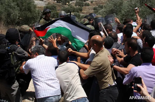 Israeli forces and Palestinian villagers scuffle during a protest against the closure of a road during the second Intifada by Jewish settlers from the nearby settlement of Kadumim , on July 01, 2011 in the West Bank vill...
