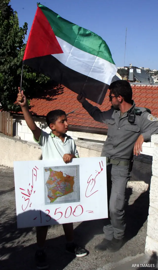 Israeli, Palestinian and foreign activists take part in a weekly demonstration against Israel's occupation of Palestinian land on July 1, 2011 in the mostly Arab Jerusalem neighborhood of Sheikh Jarrah. Photo by Mahfouz...