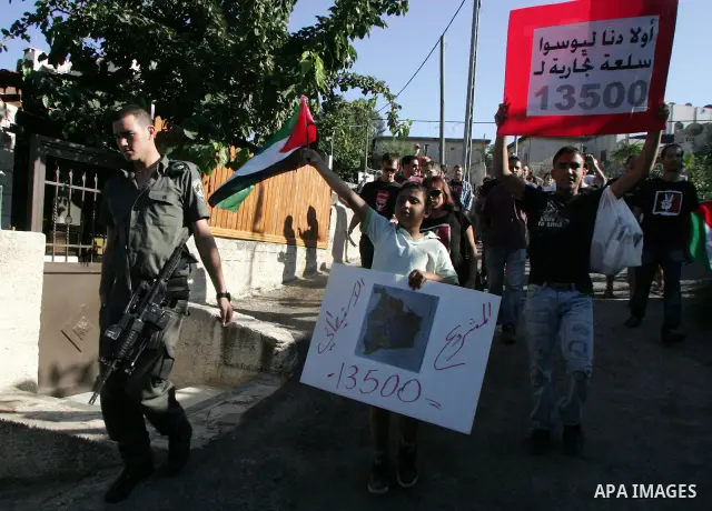 Israeli, Palestinian and foreign activists take part in a weekly demonstration against Israel's occupation of Palestinian land on July 1, 2011 in the mostly Arab Jerusalem neighborhood of Sheikh Jarrah. Photo by Mahfouz...