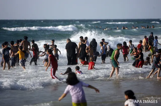 Palestinians enjoy swimming in the sea on Gaza's beach on July 1, 2011 in Gaza City. Photo by Ali Jadallah
