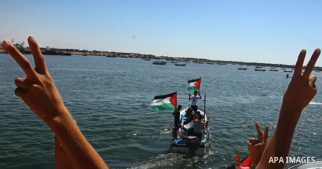 Palestinians ride on boats at the port of Gaza City during a rally in support of the Gaza-bound international Freedom Flotilla hoping to breach Israel's sea blockade on Gaza as it was banned by Greece from setting sail o...
