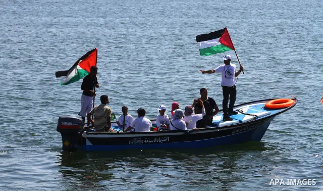 Palestinians ride on boats at the port of Gaza City during a rally in support of the Gaza-bound international Freedom Flotilla hoping to breach Israel's sea blockade on Gaza as it was banned by Greece from setting sail o...