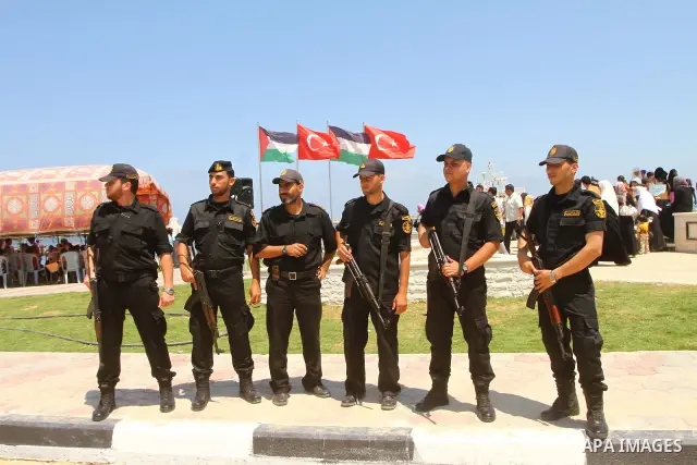 Palestinian Hamas police officers stand guard next to a memorial site in memory of nine Turkish activists who were killed in a deadly raid by the Israeli army on a Turkish aid ship bound for the Gaza Strip last year, in...