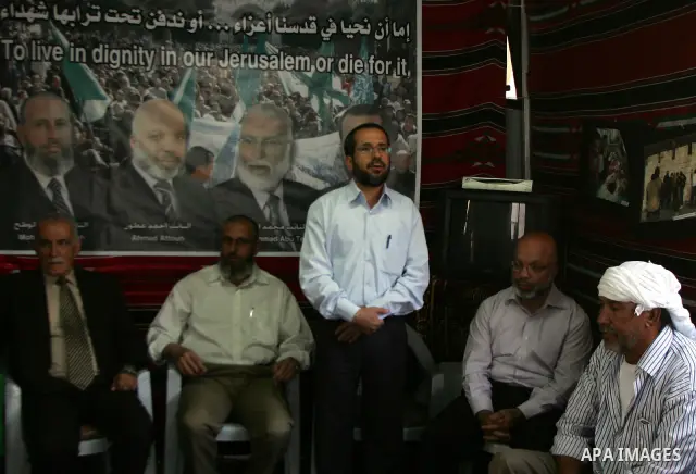 Palestinian Hamas legislators Ahmed Atun, Mohammed Totah and Khaled Abu Arafa receive Palestinian supporters at the Red Cross compound in east Jerusalem on July 3, 2011. The Hamas MPs live inside the compound for the pas...