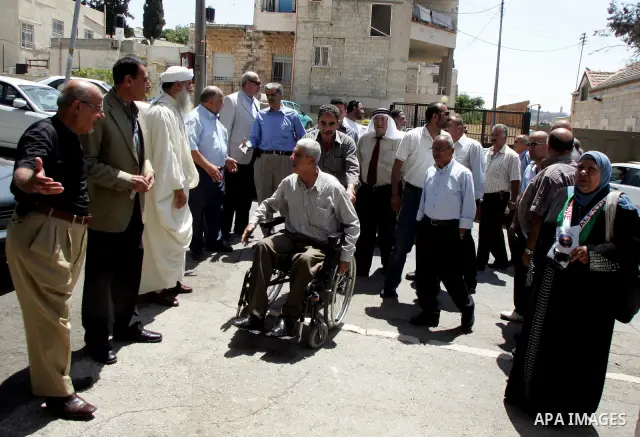 Palestinian Hamas legislators Ahmed Atun, Mohammed Totah and Khaled Abu Arafa receive Palestinian supporters at the Red Cross compound in east Jerusalem on July 3, 2011. The Hamas MPs live inside the compound for the pas...