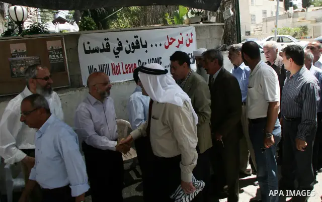 Palestinian Hamas legislators Ahmed Atun, Mohammed Totah and Khaled Abu Arafa receive Palestinian supporters at the Red Cross compound in east Jerusalem on July 3, 2011. The Hamas MPs live inside the compound for the pas...