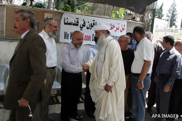 Palestinian Hamas legislators Ahmed Atun, Mohammed Totah and Khaled Abu Arafa receive Palestinian supporters at the Red Cross compound in east Jerusalem on July 3, 2011. The Hamas MPs live inside the compound for the pas...