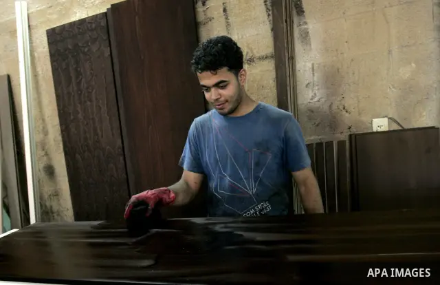 A Palestinian carpenter works at their furniture carpentry workshop in Rafah, southern Gaza Strip on July 3,2011. Photo by Abed Rahim Khatib