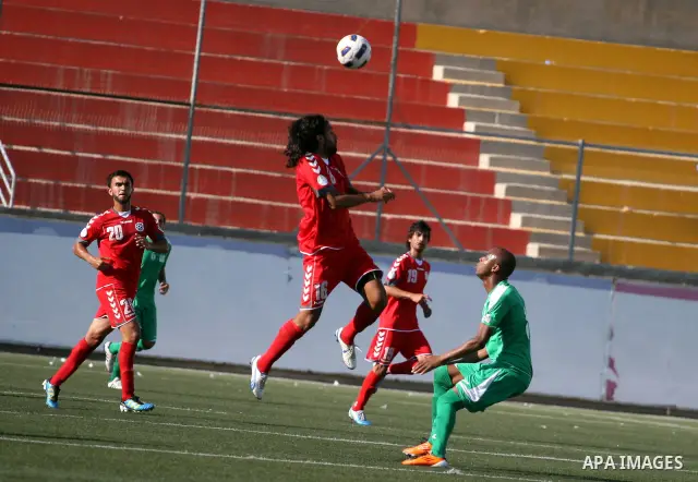 Palestinian player and Afghanistan player challenge for the ball during a soccer match between the Palestinian and Afghanistan national teams in the West bank city of Ramallah, Sunday July 3, 2011. The Palestinian nation...