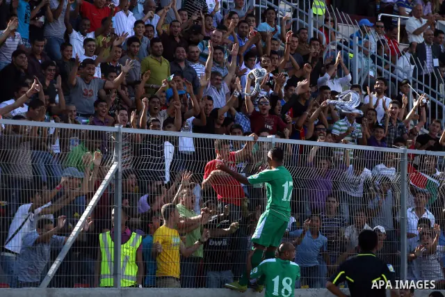 Palestinian players celebrate after a goal during a soccer match between the Palestinian and Afghanistan national teams in the West bank city of Ramallah, Sunday July 3, 2011. The Palestinian national soccer team drew 1-...