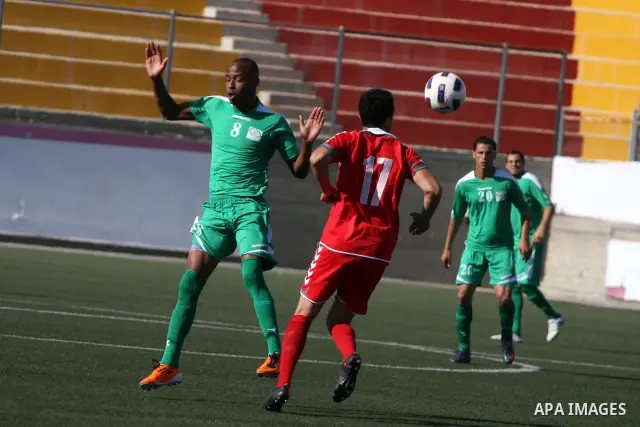 Palestinian player and Afghanistan player challenge for the ball during a soccer match between the Palestinian and Afghanistan national teams in the West bank city of Ramallah, Sunday July 3, 2011. The Palestinian nation...