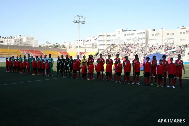 Palestinian players and Afghanistan players pose for pictures during a soccer match between the Palestinian and Afghanistan national teams in the West bank city of Ramallah, Sunday July 3, 2011. The Palestinian national...