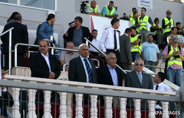 Palestinian Prime Minister Salam Fayyad attends a soccer match between the Palestinian and Afghanistan national teams in the West bank city of Ramallah, Sunday July 3, 2011. The Palestinian national soccer team drew 1-1...