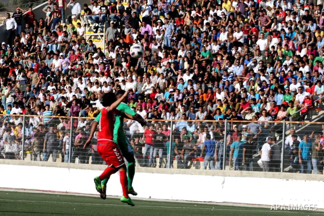 Palestinian player and Afghanistan player challenge for the ball during a soccer match between the Palestinian and Afghanistan national teams in the West bank city of Ramallah, Sunday July 3, 2011. The Palestinian nation...