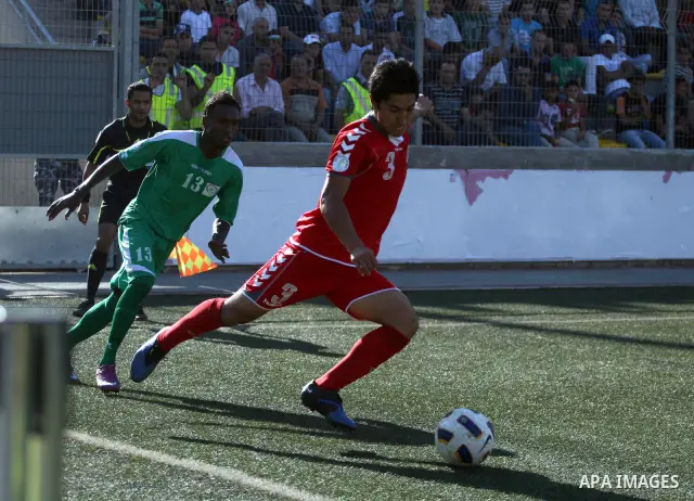 Palestinian player and Afghanistan player challenge for the ball during a soccer match between the Palestinian and Afghanistan national teams in the West bank city of Ramallah, Sunday July 3, 2011. The Palestinian nation...