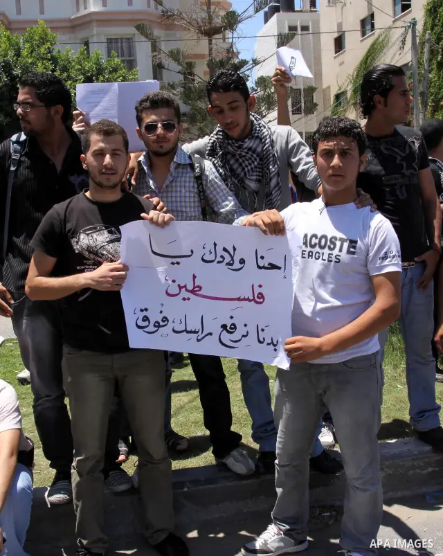 Palestinian students take a part in a protest in front of the headquarters of the Ministry of Education after the end of exams and they object to the difficulty of the exams in Gaza city on July 4, 2011. Photo by Mohamme...