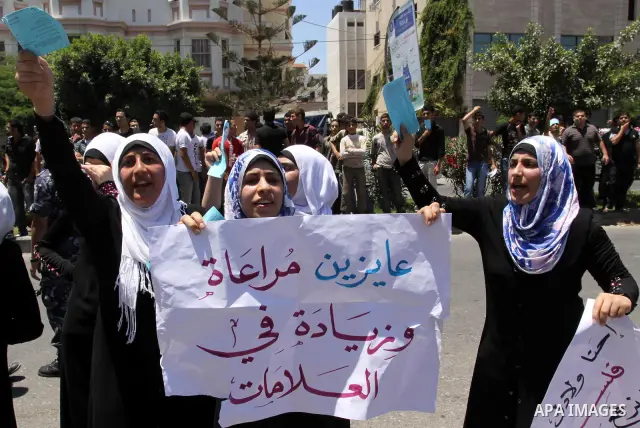 Palestinian students take a part in a protest in front of the headquarters of the Ministry of Education after the end of exams and they object to the difficulty of the exams in Gaza city on July 4, 2011. Photo by Mohamme...