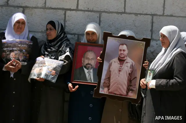 Palestinian Hamas legislators take part in a protest in front of the Red Cross compound in the West Bank city of Ramallah on July 4, 2011 in support with Jerusalem's parliament members who have been living inside the ICR...