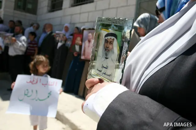 Palestinian Hamas legislators take part in a protest in front of the Red Cross compound in the West Bank city of Ramallah on July 4, 2011 in support with Jerusalem's parliament members who have been living inside the ICR...