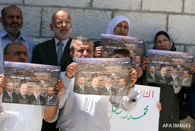 Palestinian Hamas legislators take part in a protest in front of the Red Cross compound in the West Bank city of Ramallah on July 4, 2011 in support with Jerusalem's parliament members who have been living inside the ICR...