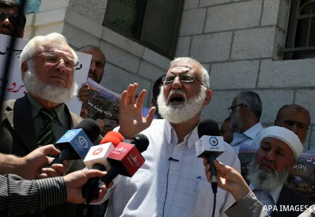 Palestinian Hamas legislators take part in a protest in front of the Red Cross compound in the West Bank city of Ramallah on July 4, 2011 in support with Jerusalem's parliament members who have been living inside the ICR...