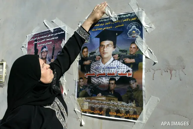 Palestinian relatives of Yousef Hanani hold his picture on July 4, 2011, in the West Bank town of Nablus, after Palestinian minister for civil affairs Hussein al-Sheikh announced that Israel is to release the bodies of 8...