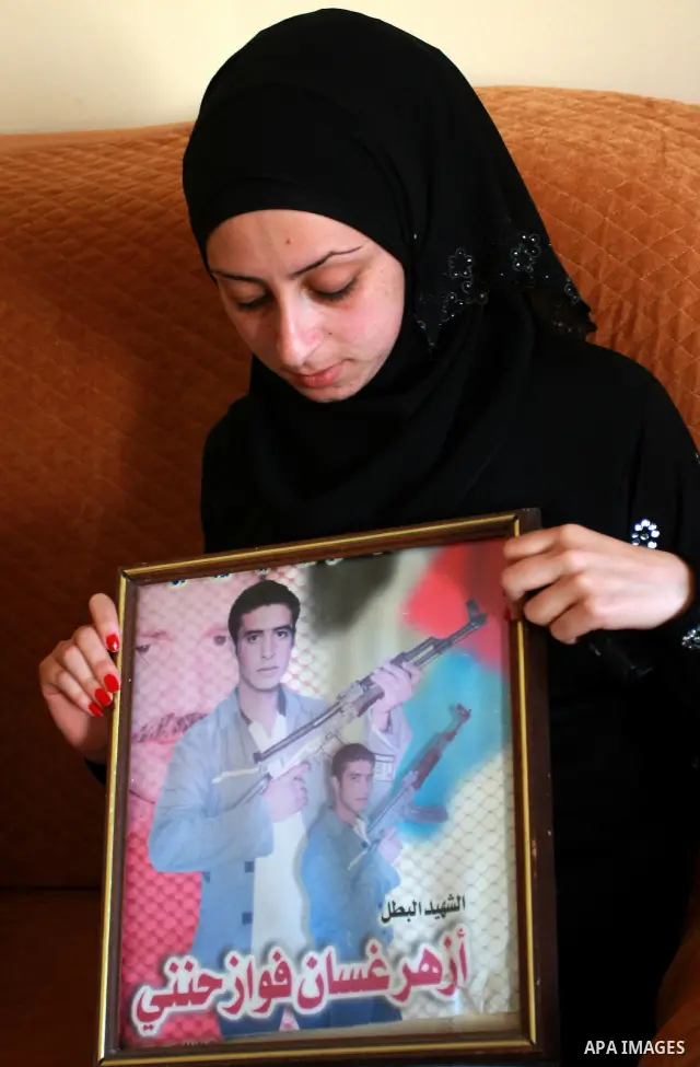 Palestinian relatives of Azhar Abu heet hold his picture on July 4, 2011, in the West Bank town of Nablus, after Palestinian minister for civil affairs Hussein al-Sheikh announced that Israel is to release the bodies of...