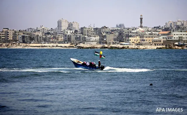 A Palestinian fisherman works on his boat in the port of Gaza City, Tuesday, July 5, 2011, as pro-Palestinian activists from an international flotilla banned from setting sail for Gaza by Greek authorities occupied the S...