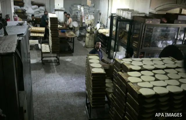 A Palestinian baker prepares bread at his bakery in Rafah, southern Gaza Strip on July 5,2011. Photo by Abed Rahim Khatib