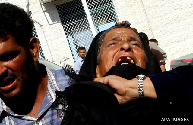 Relatives of two Palestinians killed by Israeli forces react as they arrive at the morgue of Al-Aqsa hospital in Deir Al Balah, central Gaza Strip, Tuesday, July 5, 2011. An Israeli attack struck a target along the Gaza...