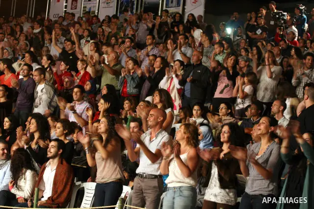 Palestinians attend a concert for Souad Massi, an Algerian singer and songwriter living in France, performs during the Palestine International Festival 2011, in the West Bank city of Ramallah, Tuesday, July 5, 2011. The...