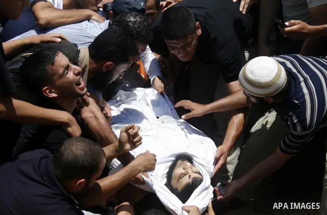 Palestinian relatives carry the body of Kamal Hamdan Muammar, 28-years-old, for burial following prayers at the mosque in the Rafah refugee camp, in the southern of Gaza Strip, on July 6, 2011, after being killed along w...