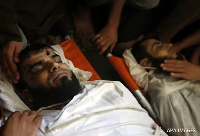 Palestinian relatives and friends of Kamal Hamdan Muammar and Mohammed Said Abu Jazar, both 28-years-old, ready to bury them following prayers at the mosque in the Rafah refugee camp, in the southern of Gaza Strip, on Ju...
