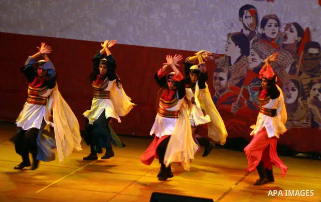 Dancers of the El-Funoun Palestinian Popular Dance Troupe perform on the third day of the 13th Palestine International Festival in the West Bank city of Ramallah on July 6, 2011. The festival, which features music and da...