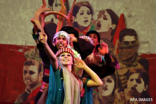 Dancers of the El-Funoun Palestinian Popular Dance Troupe perform on the third day of the 13th Palestine International Festival in the West Bank city of Ramallah on July 6, 2011. The festival, which features music and da...