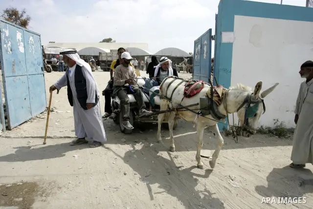 Palestinians receive humanitarian aid at the United Nations aid distribution centre in the refugee camp of Rafah in the southern Gaza Strip on July 7, 2011. United Nations Relief and Works Agency (UNRWA) decide to change...