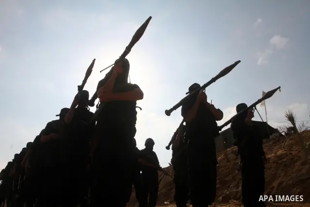 Palestinian militants of al-Ansar brigades, the military wing of al-Ahrar movement, take part in a military parade in Khan Younis in the southern Gaza Strip on July 7, 2011, to mark the fifth anniversary of their group's...