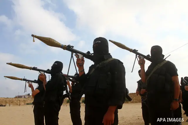 Palestinian militants of al-Ansar brigades, the military wing of al-Ahrar movement, take part in a military parade in Khan Younis in the southern Gaza Strip on July 7, 2011, to mark the fifth anniversary of their group's...