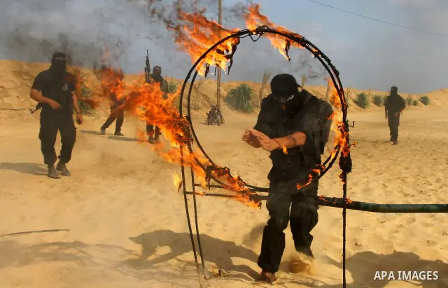 Palestinian militants from Al-Ansar brigades, the armed wing of Al-Ahrar movement, demonstrate their skills during a drill in front of the media in Khan Younis in the southern Gaza Strip July 7, 2011. Photo by Ashraf Amr...