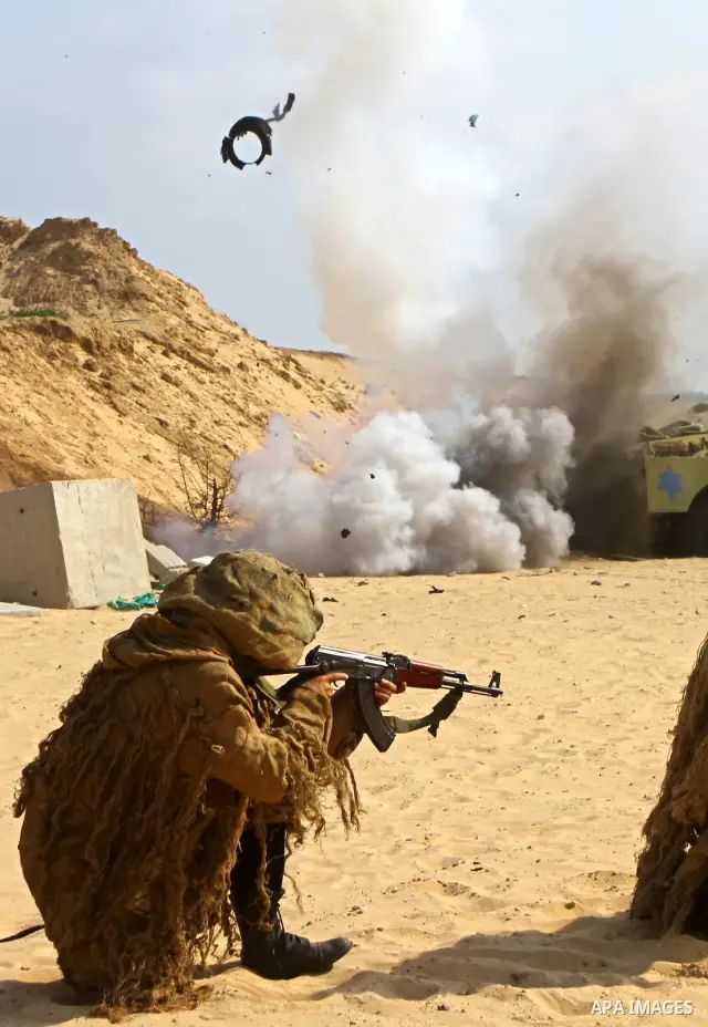 Palestinian militants from Al-Ansar brigades, the armed wing of Al-Ahrar movement, demonstrate their skills during a drill in front of the media in Khan Younis in the southern Gaza Strip July 7, 2011. Photo by Ashraf Amr...