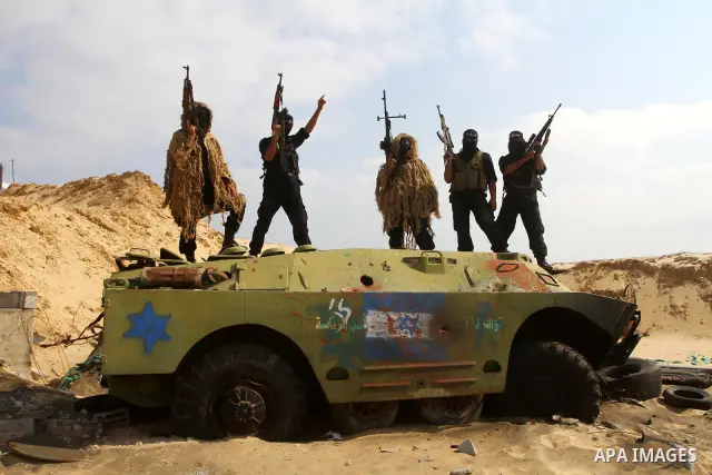 Palestinian militants of al-Ansar brigades, the military wing of al-Ahrar movement, take part in a military parade in Khan Younis in the southern Gaza Strip on July 7, 2011, to mark the fifth anniversary of their group's...