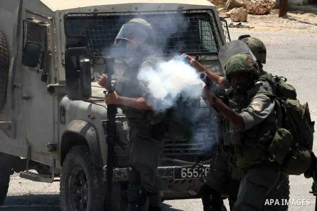 Israeli soldiers clash with Palestinian protesters from the West Bank village of Nabi Saleh, north of Ramallah, on July 8, 2011, during the weekly Friday protest against Israeli West Bank settlement expansion. Photo by I...