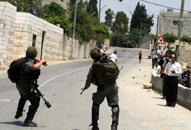 Israeli soldiers clash with Palestinian protesters from the West Bank village of Nabi Saleh, north of Ramallah, on July 8, 2011, during the weekly Friday protest against Israeli West Bank settlement expansion. Photo by I...