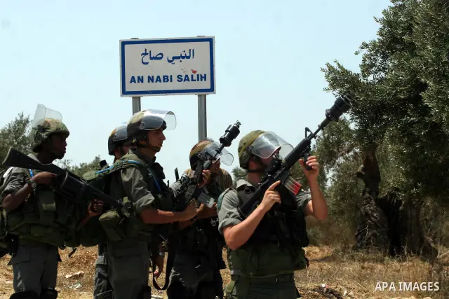Israeli soldiers clash with Palestinian protesters from the West Bank village of Nabi Saleh, north of Ramallah, on July 8, 2011, during the weekly Friday protest against Israeli West Bank settlement expansion. Photo by I...