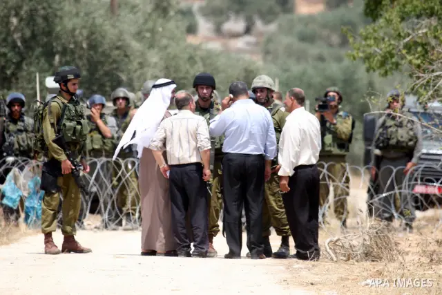 Israeli soldiers take positions as Palestinians protest in the village of Kufr Qaddum near the Israeli settlement of Kdumim, in the northern West Bank Friday, July 8, 2011. The protest concerned Palestinian access to lan...