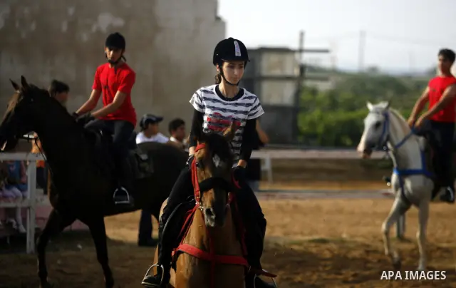Palestinian ride horses during the "Jump Championship" race in Gaza City July 8, 2011.Photo by Ali Jadallah